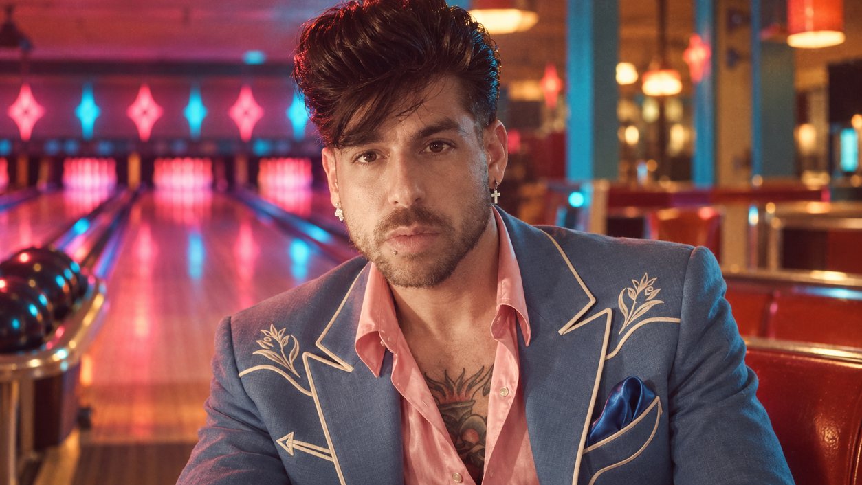 Mike Sain't Louis con chaqueta azul de bordados western y camisa rosa en una bolera de neón (serie 100 fotos retro, n.º 074, en color)